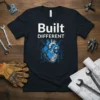Built DIFFERENT text with a blue and grey mechanical heart graphic on a black t-shirt