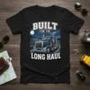BUILT FOR THE LONG HAUL text on a black t-shirt with a detailed illustration of a blue semi-truck driving on