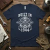 Navy blue t-shirt featuring "Built In Quality Parts 1944" text with a vintage engine graphic and wrenches