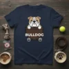 Navy t-shirt with a cartoon Bulldog peeking out of a brown pocket, text reads BULLDOG with paw prints