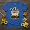 Bumble Bee Squad text design with three cute cartoon bees and floral accents on a royal blue t-shirt
