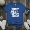 White "Bump Set Spike Repeat" text with a volleyball graphic on a royal blue t-shirt