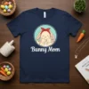 Bunny Mom T-Shirt with a mother bunny holding two baby bunnies, text reads "Bunny Mom"
