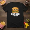 Black t-shirt featuring a cartoon burger graphic with the text "BURGER T-SHIRT" below, perfect for food lovers