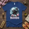 Bushido T-Shirt featuring a cat dressed as a samurai warrior, holding a sword, with a Japanese pagoda and cherry blossoms