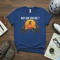 But Did You Die ? quote on a blue t-shirt with a silhouette of a person jumping across mountains at