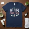 Navy t-shirt with "BUT FIRST Skin Care" text and cute skincare graphics like bottles, jars, moons, and leaves