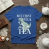 But First Tea Tea T-Shirt with a green Tyrannosaurus Rex wearing a bow tie and glasses, holding a teacup, with
