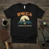 Black t-shirt with "BWCA Camping Adventure" text and a mountain landscape graphic with a campfire and two people