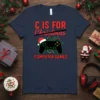 Navy t-shirt with red text "C IS FOR Christmas COMPUTER GAMES" and a black video game controller wearing a Santa