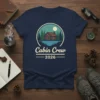 Cabin Crew 2026 t-shirt featuring a rustic cabin scene with trees and a moon, designed for group trips