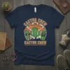 Cactus Crew T-Shirt design featuring three cartoon cacti wearing sunglasses and a sombrero, with mountains in the background