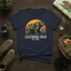 California Bear Est. 1846 t-shirt design featuring a camouflage bear graphic, sunset, and mountains