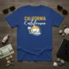 California California t-shirt with a white bear, palm tree, and sun graphic on a blue background