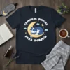Camiseta Oficial Para Dormir t-shirt design with a blue and white cat sleeping on a yellow moon, surrounded by stars