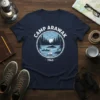 Camp Arawak 1963 t-shirt design featuring a vintage lake scene with canoes, sailboat, and pine trees under a crescent moon