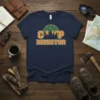 Navy t-shirt with "CAMP DIRECTOR" text in orange and white, featuring a green arch with trees and moon graphic