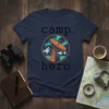 Camp Hero t-shirt design with pixelated text, satellite dish, mountains, and aurora borealis graphic