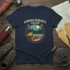 Camping Cookouts & Kayaking graphic tee featuring a tent, campfire, kayak, and forest scene