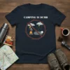 Dark blue t-shirt with white text "CAMPING IS DUMB" and a red crossed-out graphic of a campfire and a person