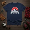 Navy t-shirt with "CANADA" text on a banner, set against a red circle with mountains and a white maple leaf