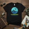 Black t-shirt with a circular graphic depicting the Canberra Australia skyline, featuring Parliament House, Telstra Tower, a bird, and a