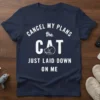 White text on navy t-shirt reads "CANCEL MY PLANS the CAT JUST LAID DOWN ON ME" with a sleeping cat
