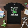 CAN'T YOU SEE MY ARMISSAUR T-Shirt featuring a green cartoon dinosaur with a broken arm in a shield graphic