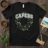 Black t-shirt with "CAPERS" text in white varsity font, surrounded by a green wreath with white and purple berries