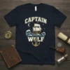Captain Wolf text above a sailing ship on waves with an anchor below, navy blue t-shirt