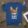 Brown tabby cat face graphic with "CAT FACE" text in white on a blue t-shirt