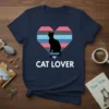 Navy t-shirt with white text "CAT LOVER" below a heart graphic containing a black cat silhouette and colorful stripes