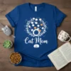 Blue t-shirt with "Cat Mom" text and a circular design of various cat faces within a leafy wreath