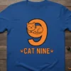 Blue t-shirt with "CAT NINE" text and a cute orange tabby cat sleeping on the number nine