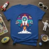 Cat Rocket Alien T-Shirt design featuring a cartoon cat in a rocket ship with UFOs and planets, vibrant colors