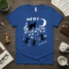 Blue t-shirt with black cats dancing on musical notes, featuring 'mf P f fp ff ritardando' text and a crescent