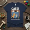 Cats! Pocket Adventures t-shirt design with multiple cute cats peeking out of a denim pocket, featuring playful typography