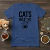 Black text "CATS RULE THE WORLD" with a cat graphic on a navy blue t-shirt