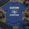 Blue t-shirt with "CAUTION EXTREME GAMER" text and a dragon logo wearing headphones