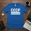 CCCP text in white with two horizontal lines below on a blue t-shirt, representing Soviet Union history