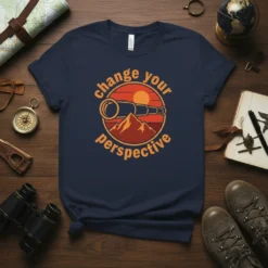 Change Your Perspective quote with a vintage telescope over mountains and a sunset graphic on a navy blue t-shirt