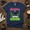 Changed for Good t-shirt with a black raven flying over an open book and neon green swirls