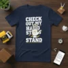 CHECK OUT MY HAND STAND text with a graphic of a hand in a handstand position on a navy t-shirt
