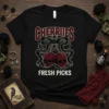 Cherries Fresh Picks t-shirt design with two skull-shaped cherries hanging from a bow, surrounded by thorny vines and berries
