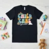 Retro groovy t-shirt design for Child Care Director featuring colorful bubble letters, castles, sun, and clouds