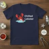 Chilled Lobster T-Shirt with a cartoon lobster wearing sunglasses and a gold chain, sitting on ice, with white text