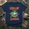 Navy t-shirt with "CHILLIN' with my Zombies" text and cartoon zombies relaxing on a beach, featuring tropical palms and a