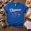 Chismosa t-shirt with a colorful hummingbird and speech bubbles, featuring white script text