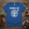 Blue t-shirt with "CHOOSE LIFE" text above a white graphic of a Tree of Life, dove, and open book
