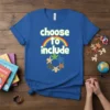 Blue t-shirt with the text "choose to include" above a rainbow and diverse figures holding hands